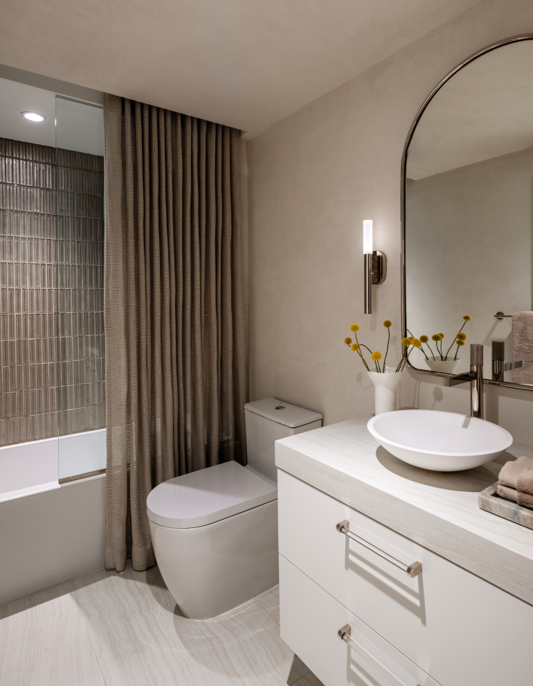 Bathroom - contemporary gray tile gray floor and single-sink bathroom idea in Miami with flat-panel cabinets, white cabinets, beige walls, a vessel sink, gray countertops and a floating vanity