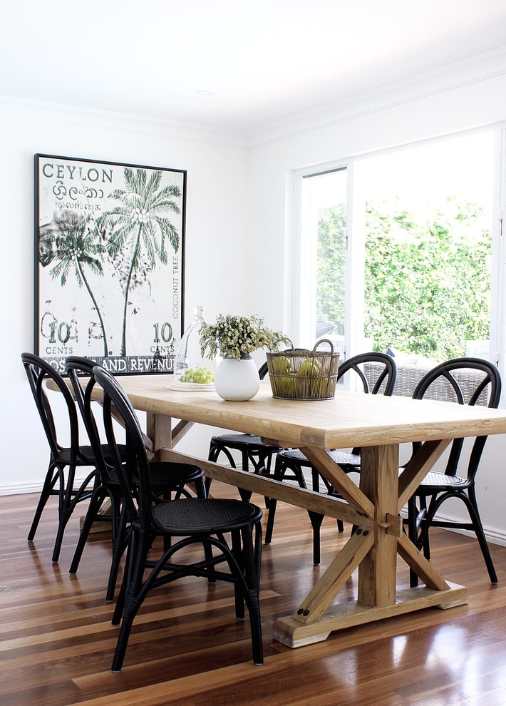 Inspiration for a large beach style dining room in Sydney with white walls, medium hardwood floors and brown floor.