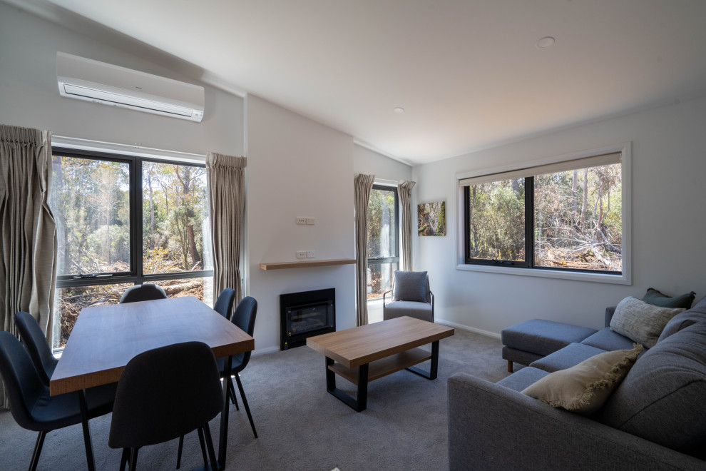Inspiration for a traditional living room in Adelaide with carpet, a standard fireplace and grey floor.