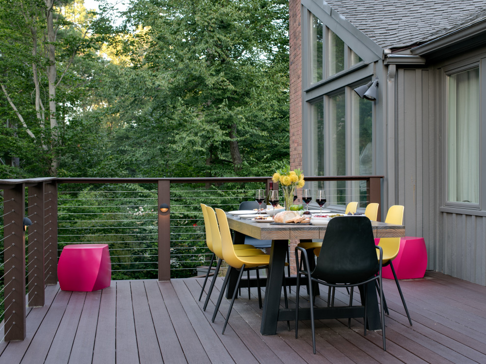 Large midcentury backyard deck in Boston with a fire feature and no cover.