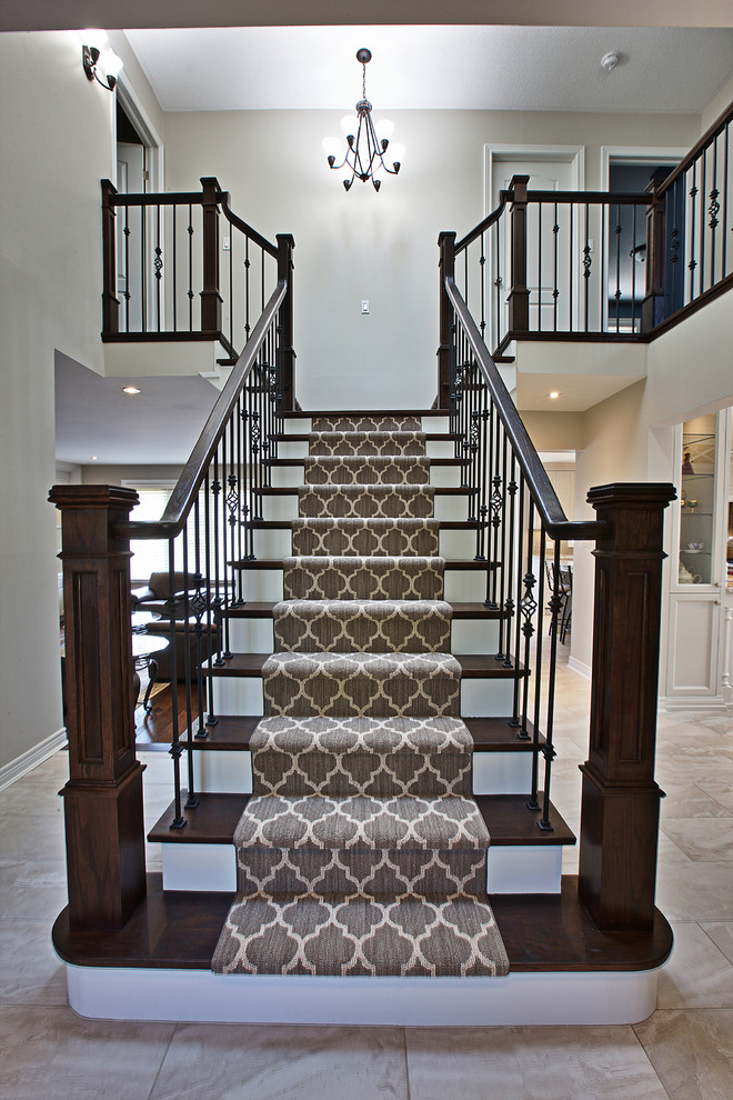Inspiration for a mid-sized transitional wood straight staircase in Toronto with painted wood risers.
