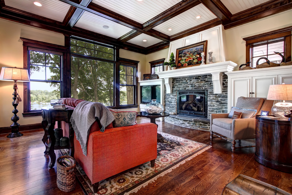 Photo of a traditional living room in Minneapolis with beige walls, a standard fireplace and a stone fireplace surround.