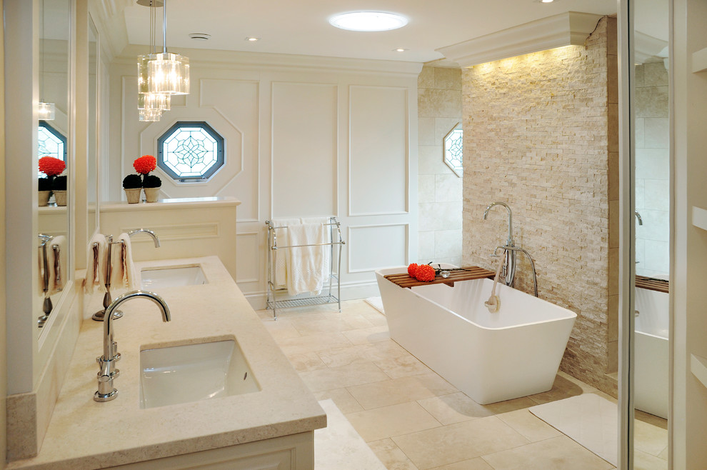 Photo of a large transitional master bathroom in Toronto with an undermount sink, recessed-panel cabinets, marble benchtops and a freestanding tub.
