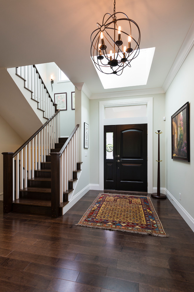 Large transitional medium tone wood floor foyer photo in Vancouver with gray walls and a dark wood front door