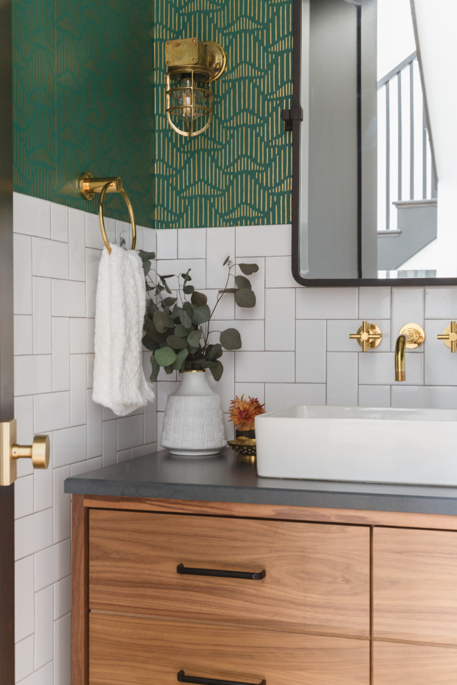 Design ideas for a scandinavian powder room in Chicago with flat-panel cabinets, light wood cabinets, white tile, subway tile, green walls, a vessel sink, grey benchtops and wallpaper.