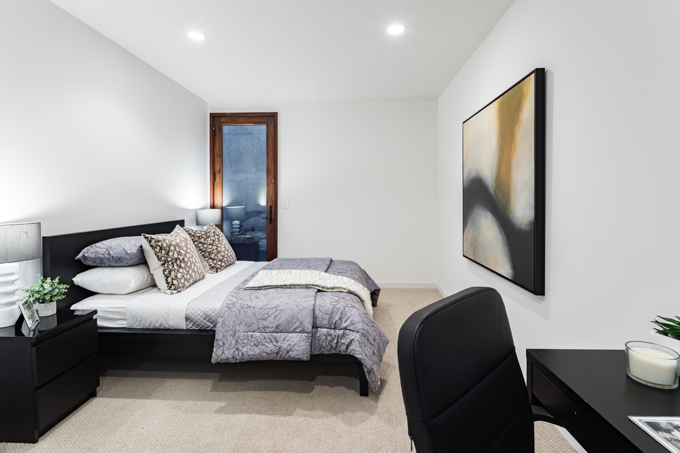 This is an example of a large modern guest bedroom in San Francisco with white walls, carpet and beige floor.