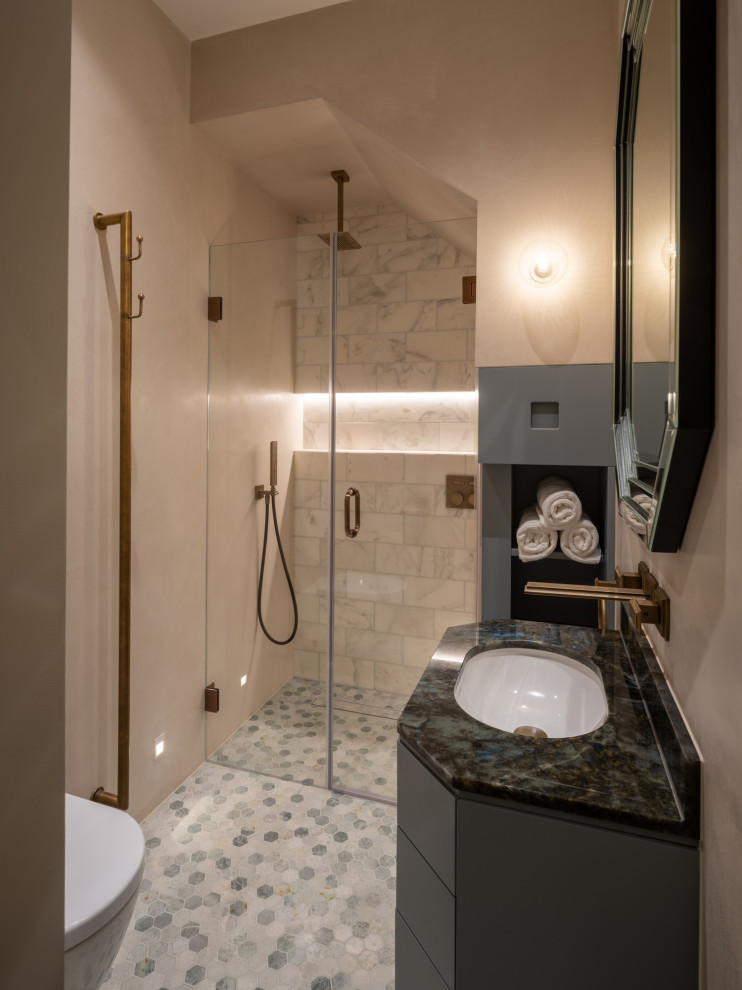 Photo of a small traditional master bathroom in London with flat-panel cabinets, blue cabinets, an open shower, a wall-mount toilet, white tile, marble, beige walls, mosaic tile floors, an undermount sink, granite benchtops, green floor, a hinged shower door, blue benchtops, a shower seat, a single vanity and a built-in vanity.