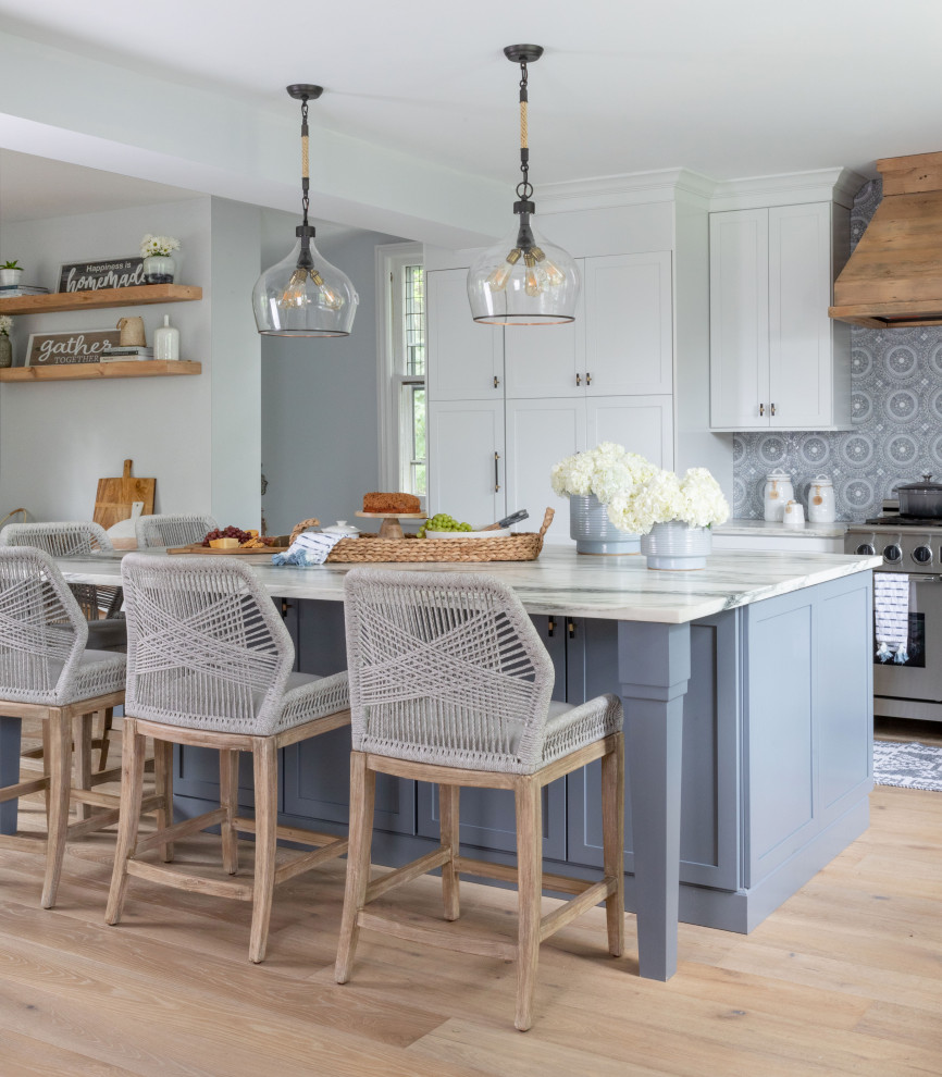 Inspiration for a country eat-in kitchen in New York with blue splashback, stainless steel appliances and with island.