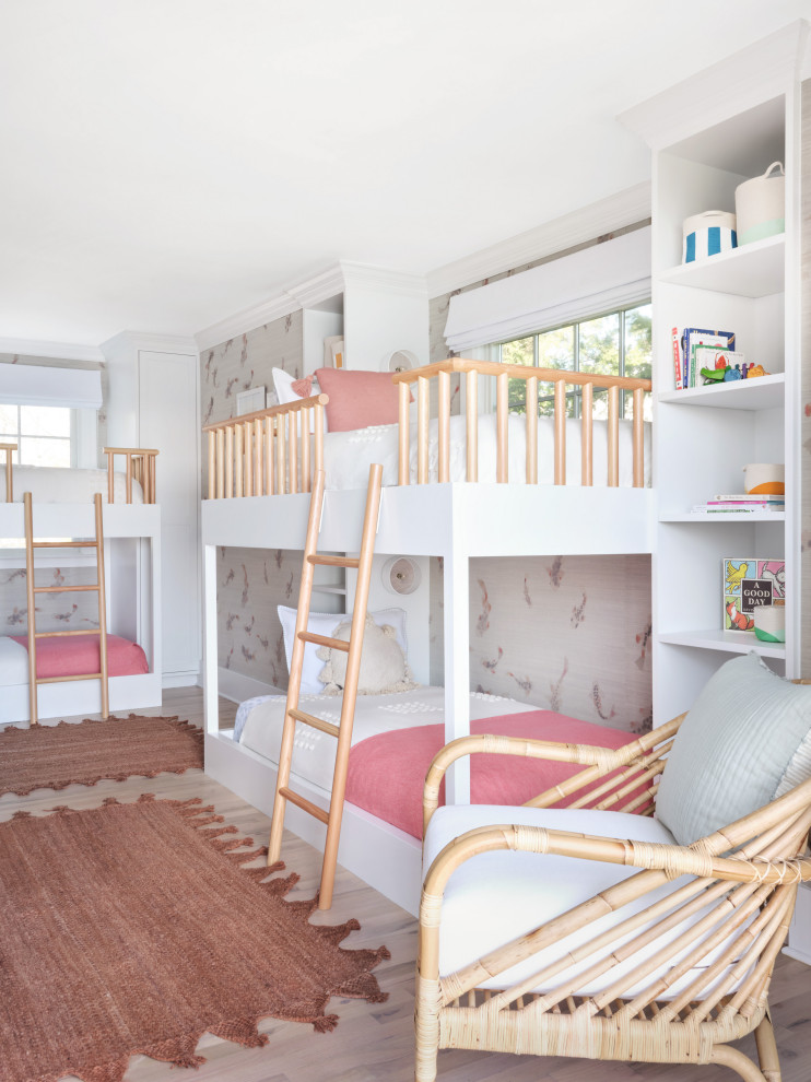 Inspiration for a medium sized coastal children’s room for girls in New York with multi-coloured walls, light hardwood flooring and brown floors.