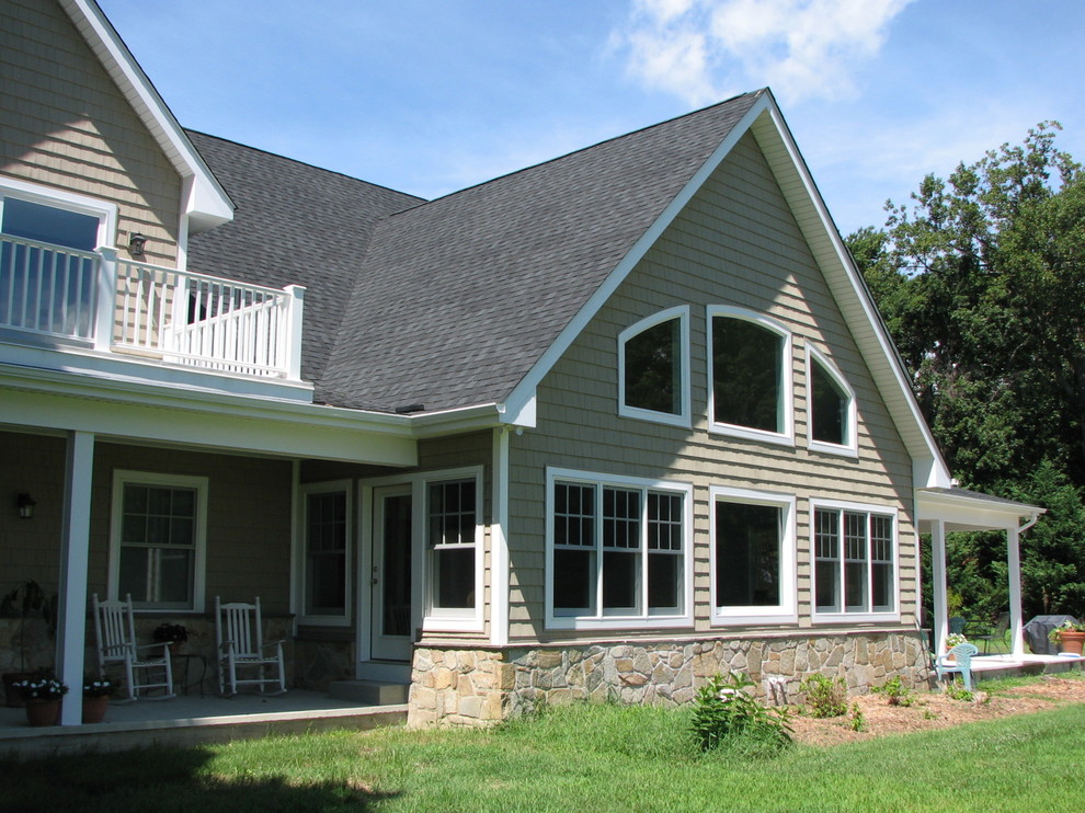 Large traditional two-storey brown house exterior in Baltimore with wood siding, a gable roof and a shingle roof.