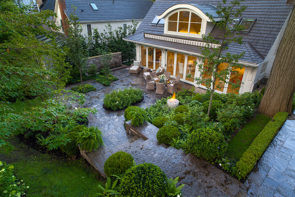 This is an example of a beach style backyard garden in Toronto with a fire feature.