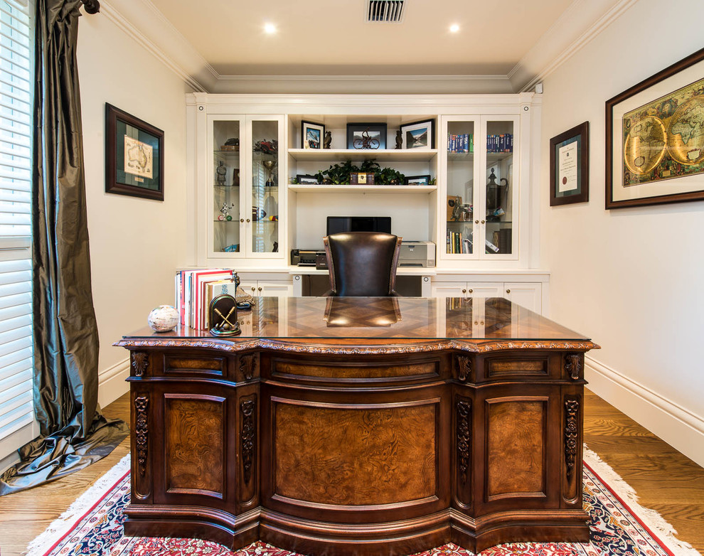 Traditional study room in Melbourne with medium hardwood floors and a freestanding desk.