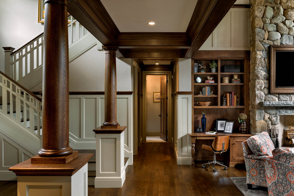 Photo of a large arts and crafts foyer in Boston with white walls, dark hardwood floors, brown floor, coffered and decorative wall panelling.