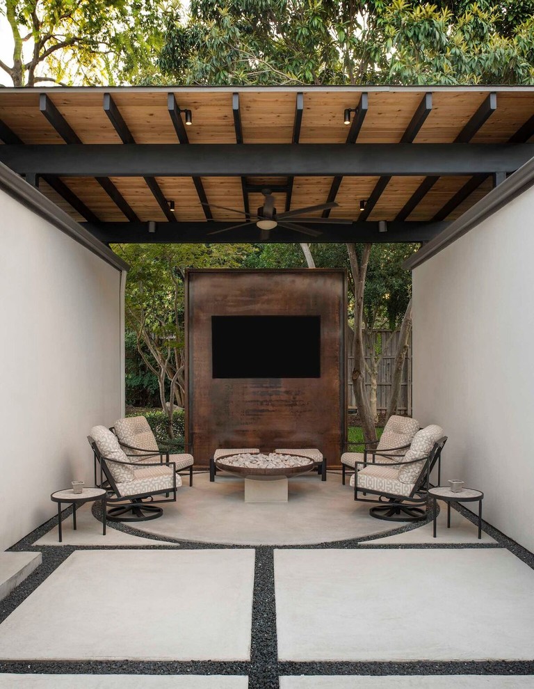 This is an example of a large modern backyard patio in Dallas with a fire feature, concrete pavers and a gazebo/cabana.