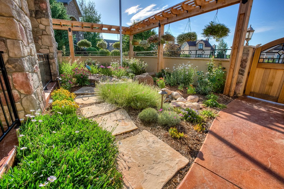 Inspiration for a mid-sized transitional partial sun front yard stone walkway in Denver.