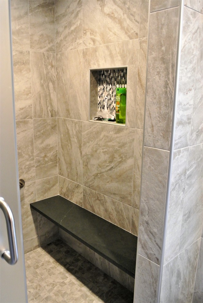 Transitional master gray tile and ceramic tile porcelain tile and gray floor bathroom photo in Boston with raised-panel cabinets, white cabinets, beige walls, quartz countertops and black countertops