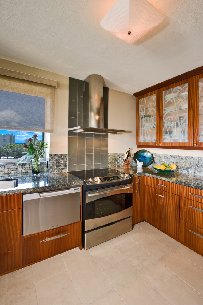 Photo of a mid-sized contemporary l-shaped eat-in kitchen in Hawaii with an undermount sink, flat-panel cabinets, medium wood cabinets, granite benchtops, multi-coloured splashback, glass tile splashback, stainless steel appliances, ceramic floors, no island and beige floor.