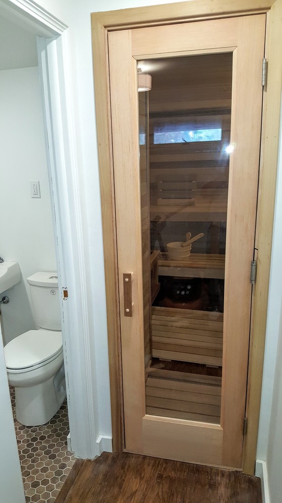 Mid-sized scandinavian bathroom in Other with white walls, laminate floors and brown floor.