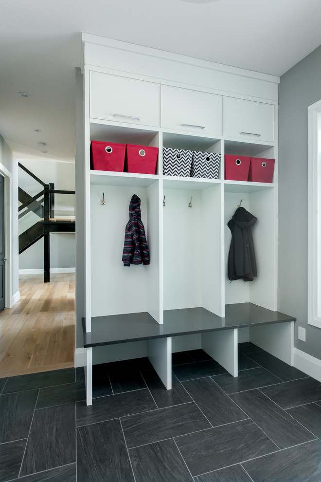 Photo of a mid-sized transitional mudroom in Edmonton with grey walls and ceramic floors.