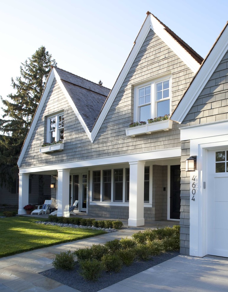 Design ideas for a large traditional two-storey grey exterior in Minneapolis with wood siding and a gable roof.