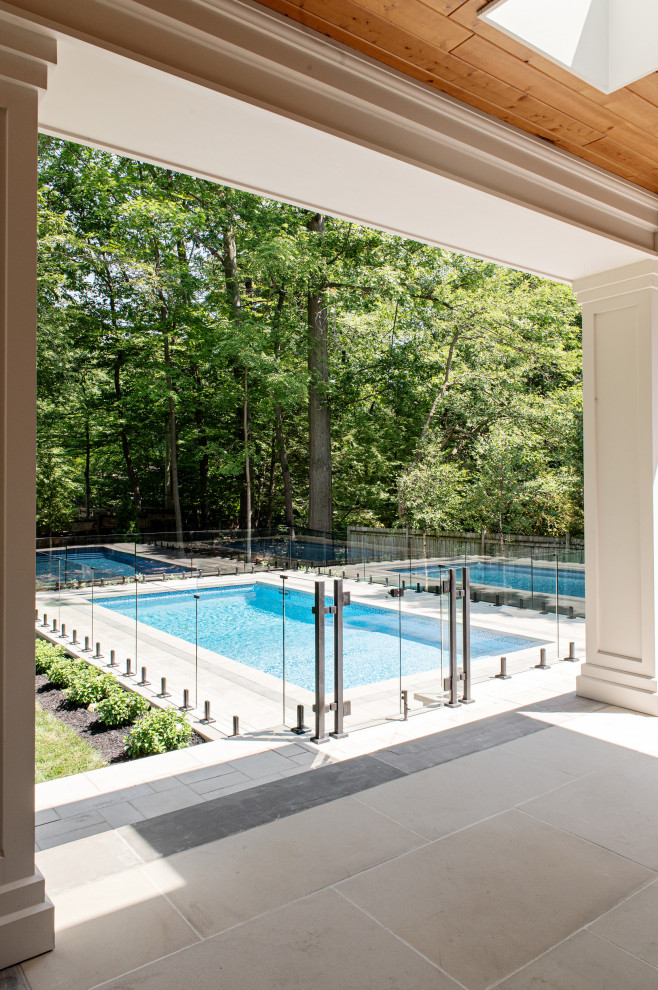 Pool landscaping - large transitional backyard concrete paver and rectangular pool landscaping idea in Toronto