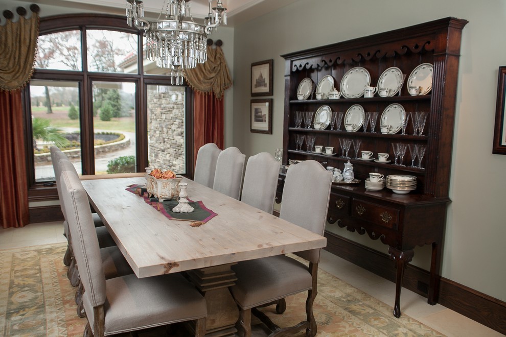 Photo of a traditional kitchen/dining combo in Other with grey walls and limestone floors.