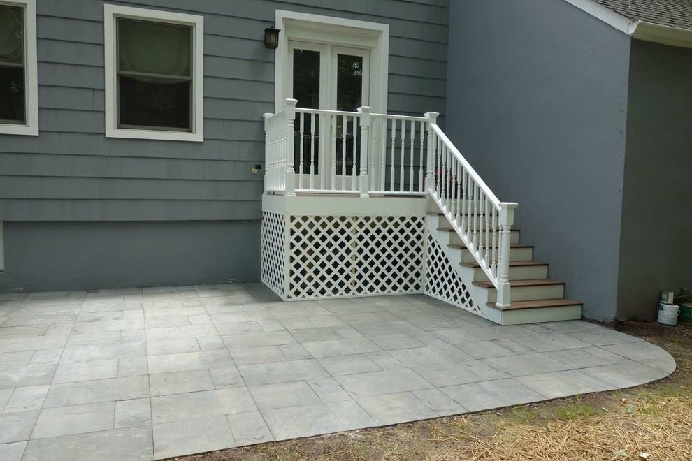 This is an example of a small traditional front yard patio in New York with concrete pavers.