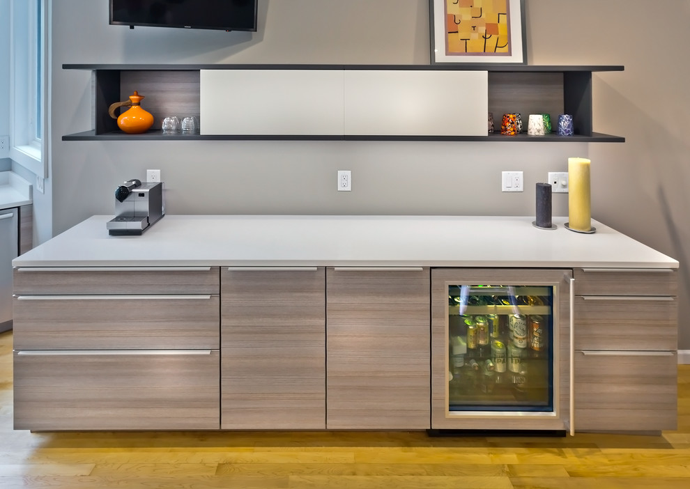 Design ideas for a large transitional galley eat-in kitchen in Minneapolis with an undermount sink, flat-panel cabinets, grey cabinets, granite benchtops, white splashback, glass sheet splashback, stainless steel appliances, medium hardwood floors and with island.