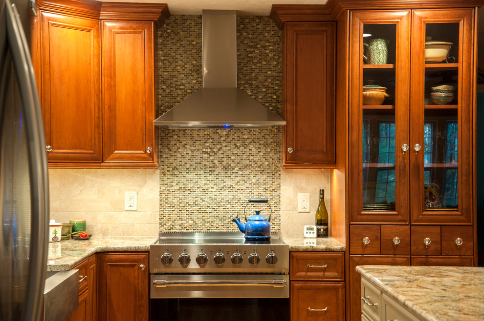 Mid-sized transitional l-shaped medium tone wood floor eat-in kitchen photo in Boston with a farmhouse sink, flat-panel cabinets, medium tone wood cabinets, granite countertops, beige backsplash, subway tile backsplash, stainless steel appliances and an island