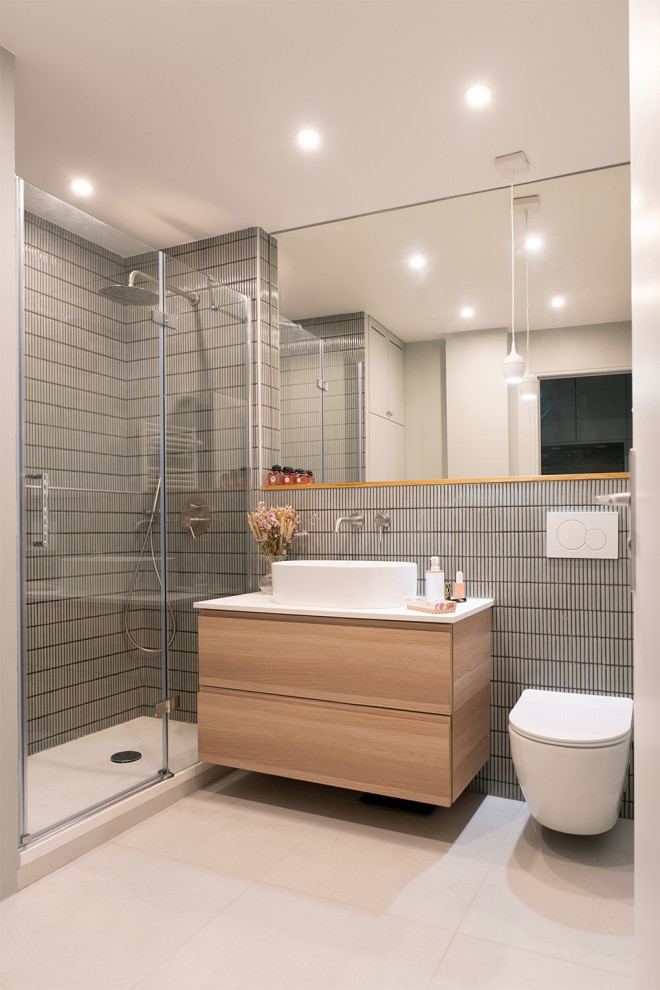 This is an example of a mid-sized contemporary bathroom in Paris with flat-panel cabinets, light wood cabinets, a curbless shower, a wall-mount toilet, green tile, green walls, a drop-in sink, laminate benchtops, beige floor, a hinged shower door, white benchtops, a laundry, a single vanity and a floating vanity.