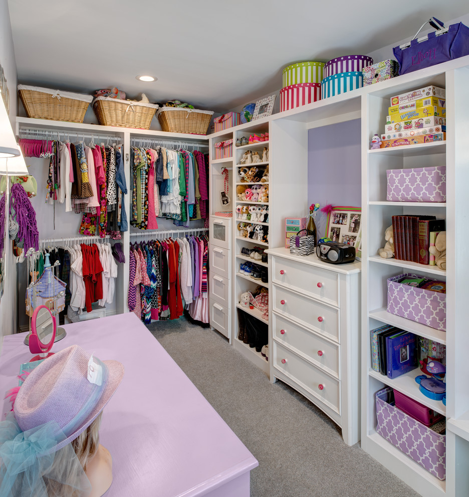 Design ideas for a traditional women's walk-in wardrobe in Other with white cabinets and carpet.