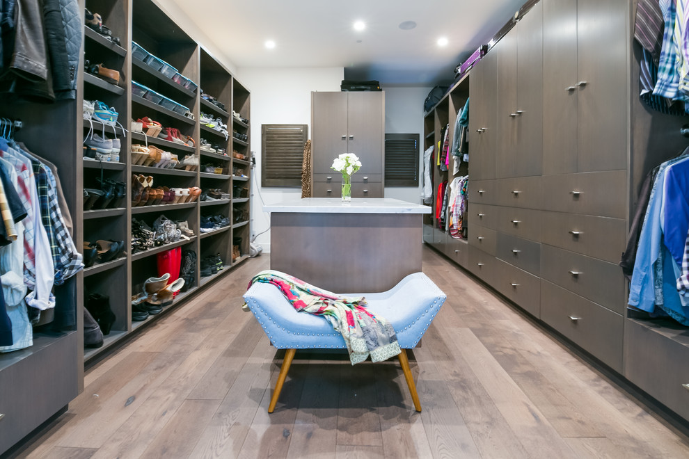 Design ideas for a large transitional gender-neutral walk-in wardrobe in San Francisco with flat-panel cabinets, dark wood cabinets, dark hardwood floors and brown floor.