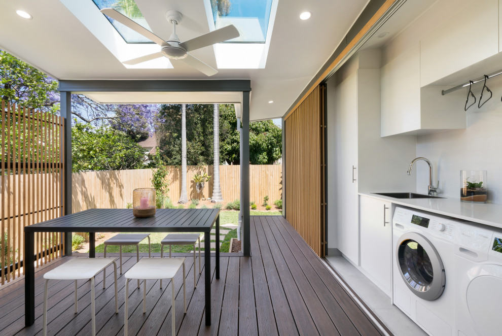 Design ideas for a contemporary deck in Sydney with a roof extension.