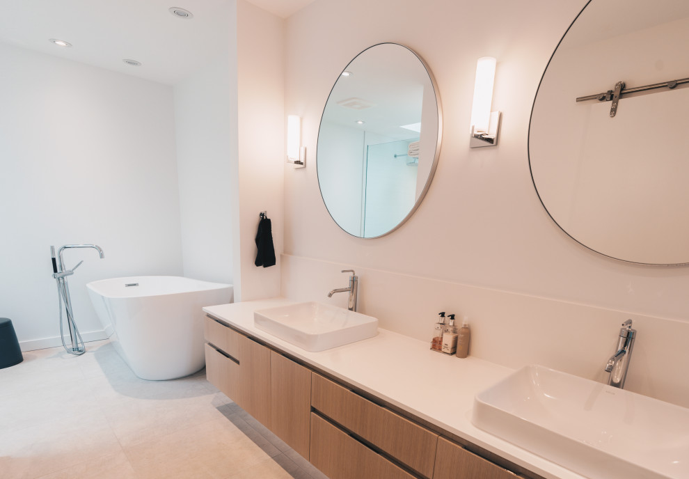 Inspiration for a large contemporary master bathroom in Vancouver with raised-panel cabinets, white cabinets, a corner shower, a one-piece toilet, white tile, ceramic tile, white walls, ceramic floors, an integrated sink, grey floor, an open shower and white benchtops.