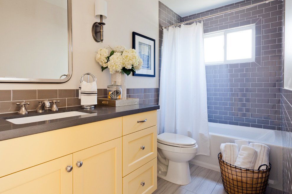 Inspiration for a beach style kids bathroom in Los Angeles with shaker cabinets, yellow cabinets, engineered quartz benchtops, gray tile, ceramic tile and ceramic floors.