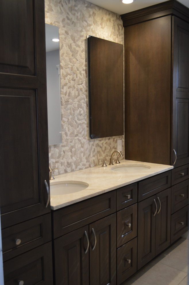 Bathroom - mid-sized transitional master beige tile and cement tile bathroom idea in Boston with raised-panel cabinets, dark wood cabinets, a hot tub, an undermount sink, quartz countertops and beige countertops