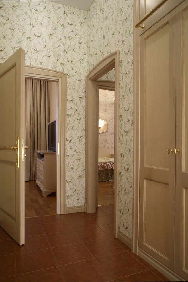 This is an example of a mid-sized traditional hallway in Moscow with multi-coloured walls, porcelain floors and brown floor.