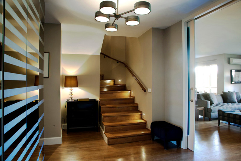 This is an example of a contemporary entryway in Other with grey walls and painted wood floors.