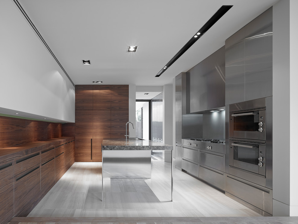 This is an example of a large modern separate kitchen in Melbourne with an undermount sink, flat-panel cabinets, medium wood cabinets, marble benchtops, grey splashback, stainless steel appliances, travertine floors and with island.