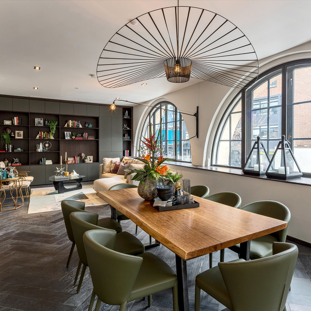 Contemporary open plan dining in London with beige walls, dark hardwood floors and brown floor.