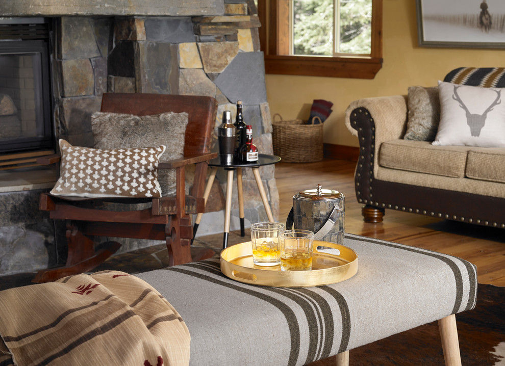 Inspiration for a large country open concept living room in San Francisco with yellow walls, medium hardwood floors, a two-sided fireplace and a stone fireplace surround.