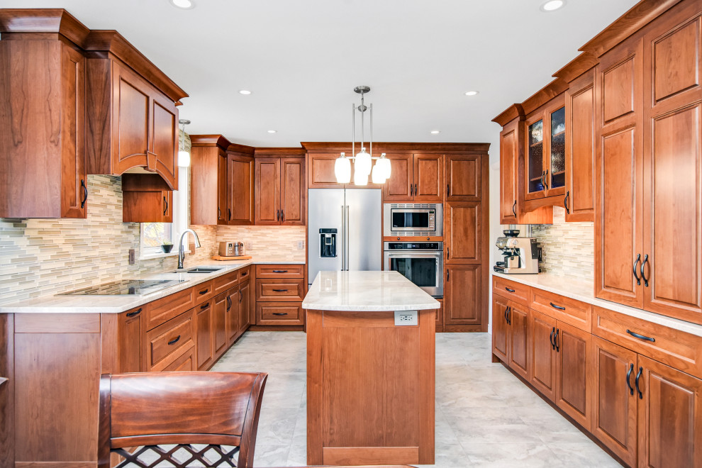 Example of a large transitional u-shaped porcelain tile and beige floor open concept kitchen design in Ottawa with an undermount sink, raised-panel cabinets, medium tone wood cabinets, quartzite countertops, multicolored backsplash, glass sheet backsplash, stainless steel appliances, an island and beige countertops