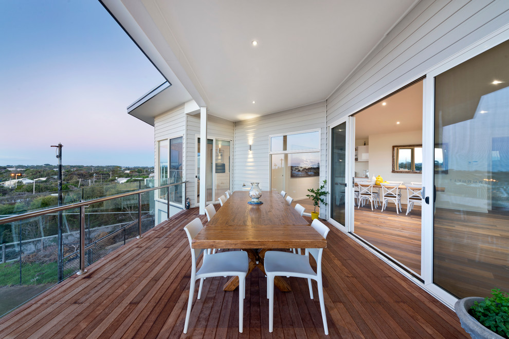 Photo of a beach style balcony in Melbourne with a roof extension.