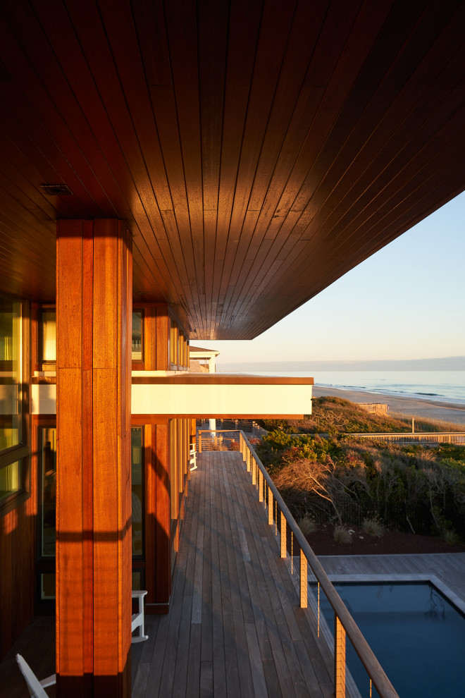 Example of a large minimalist brown split-level wood and shingle flat roof design