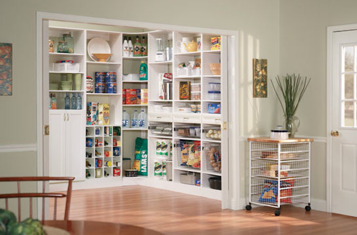 Photo of a traditional kitchen pantry in Other with louvered cabinets and white cabinets.