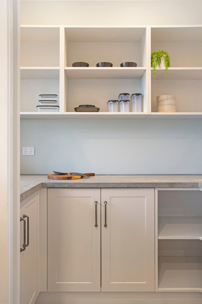 Design ideas for a mid-sized country u-shaped separate kitchen in Hamilton with a double-bowl sink, shaker cabinets, blue cabinets, concrete benchtops, grey splashback, stainless steel appliances, ceramic floors, a peninsula, grey floor and grey benchtop.