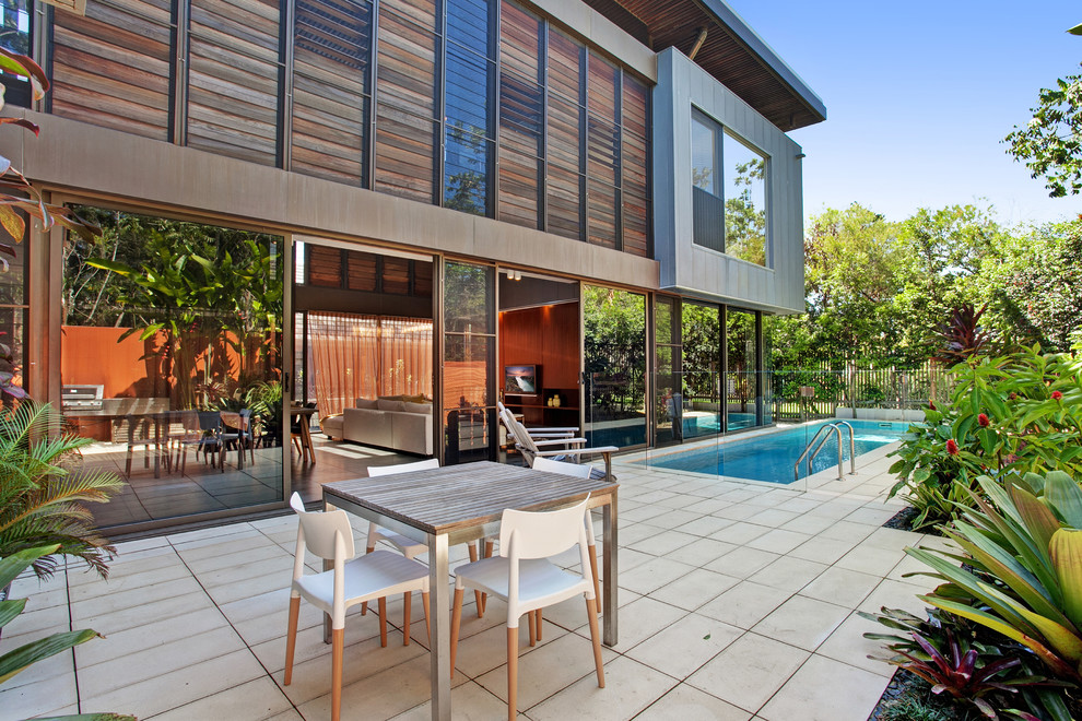 Inspiration for a contemporary side yard patio in Sunshine Coast with tile and no cover.