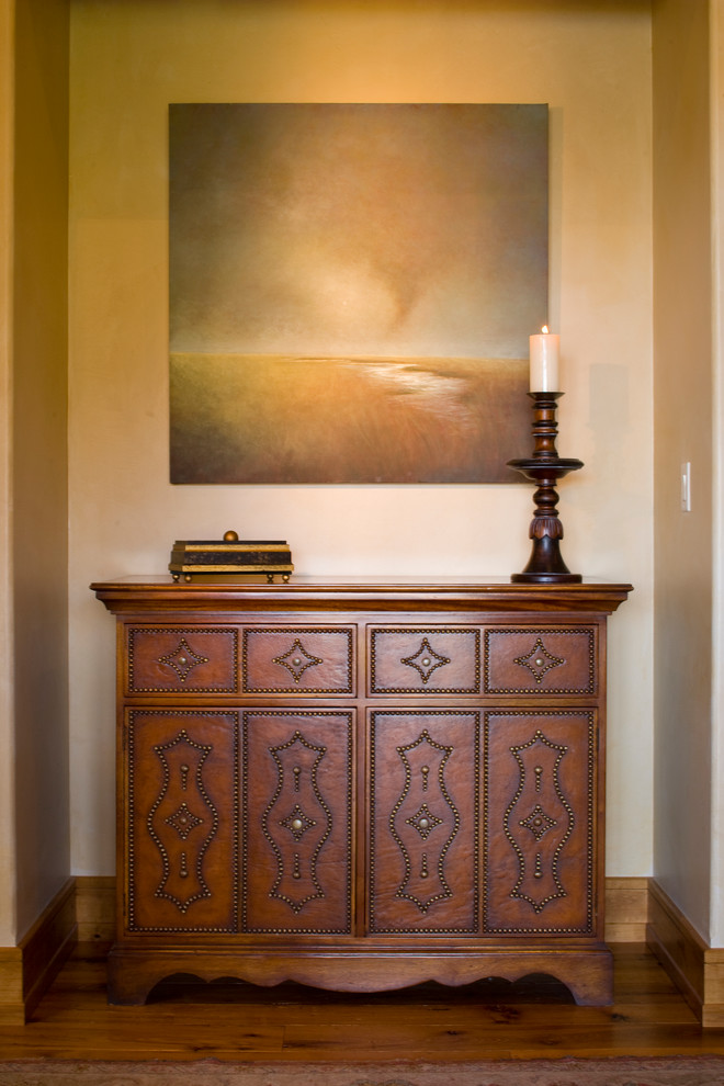 Mid-sized transitional medium tone wood floor hallway photo with beige walls