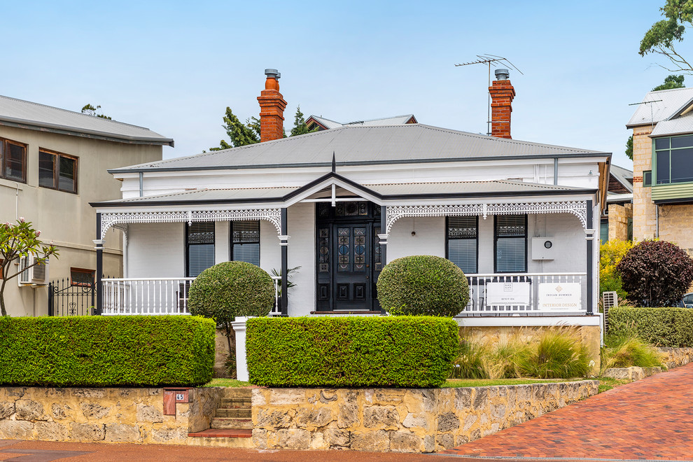 Photo of a traditional one-storey brick white house exterior in Perth with a metal roof and a hip roof.