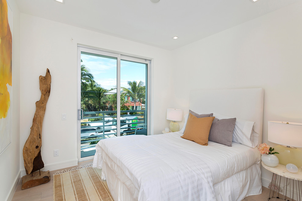 Inspiration for a large contemporary master bedroom in Miami with white walls, light hardwood floors and beige floor.